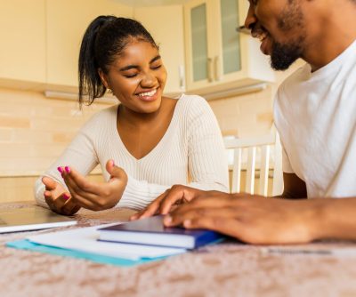 african american couple managing finances bank using laptop kitchen min scaled e1760197712727