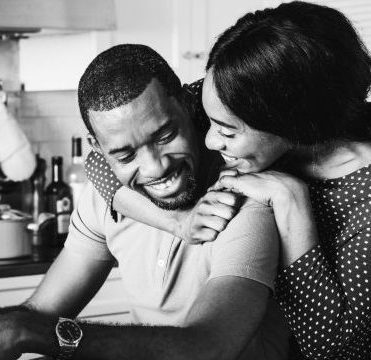 african couple hugging together kitchen min scaled e1768894930178