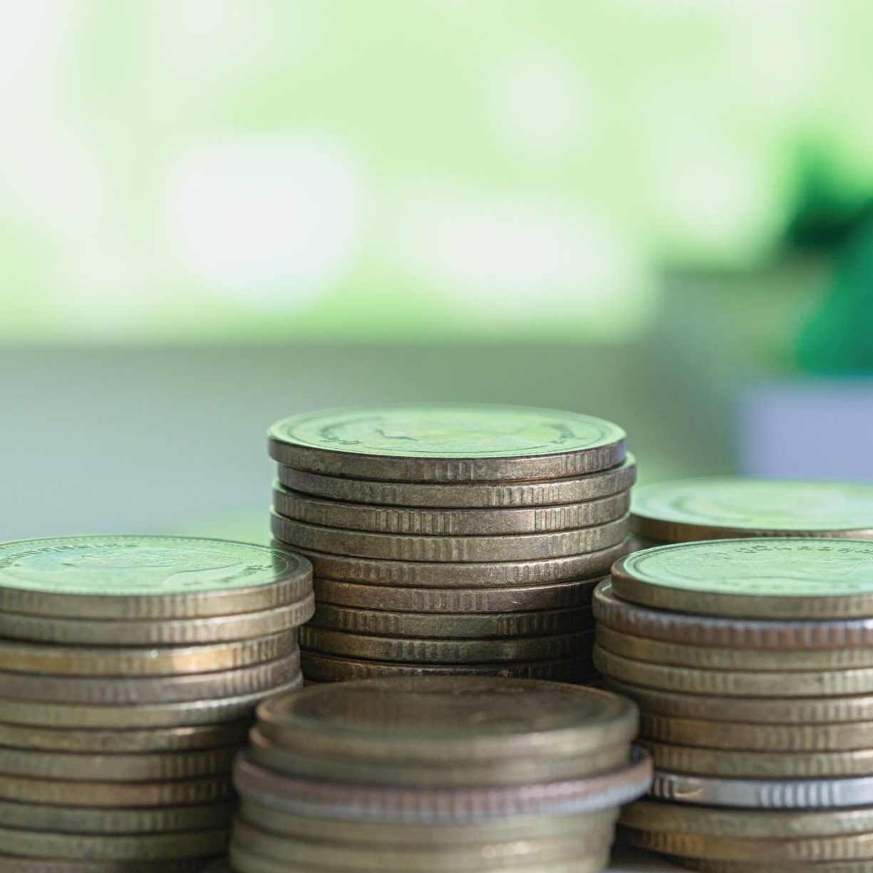 model house with coins wooden table min scaled e1760202525264