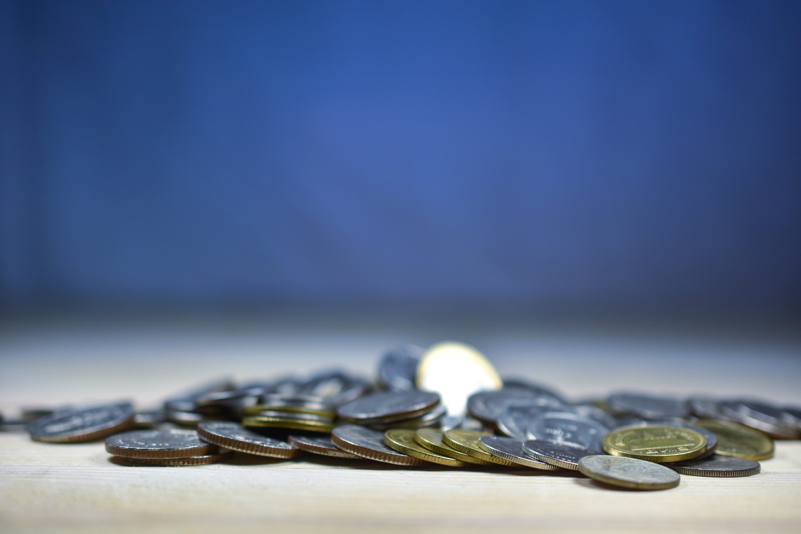 thai baht coin wood table finance wealth coin currency business indoors savings metal close up min scaled